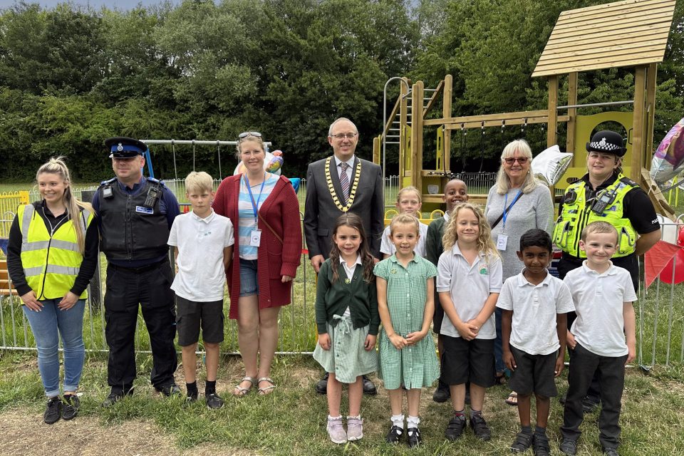 Nick Baker Chair of the Parish Council with Cllrs Waller and jones, Children from Greentrees Primary School, PC Rachel Gunn and PCSO Taylor, at the ribbon cutting for St Peters Play Park