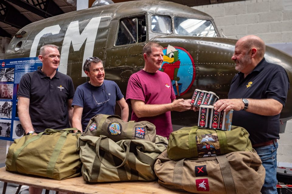 four men demonstrate parachute packing fas part of DDay celebrations at BDAC