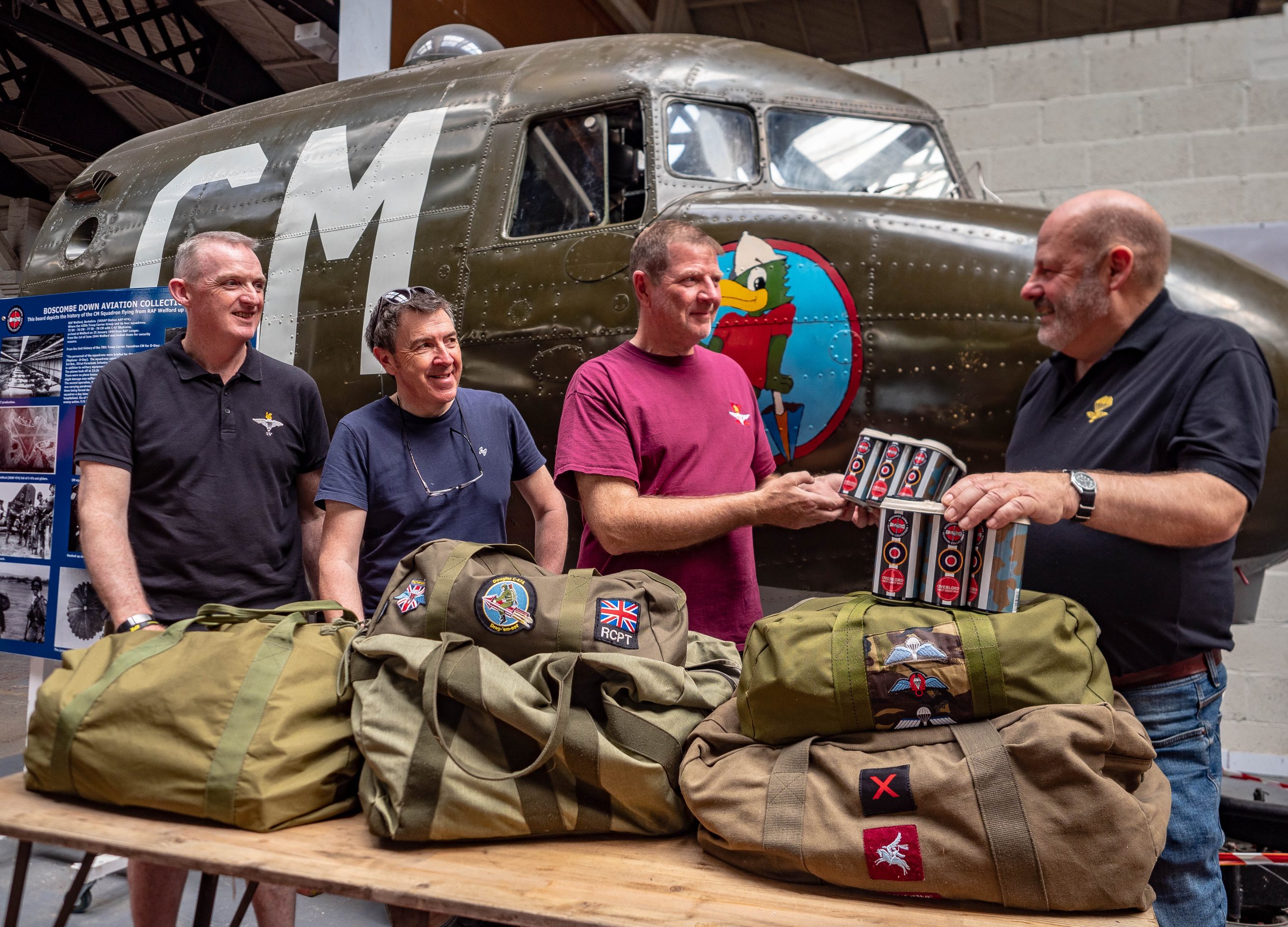 four men demonstrate parachute packing fas part of DDay celebrations at BDAC